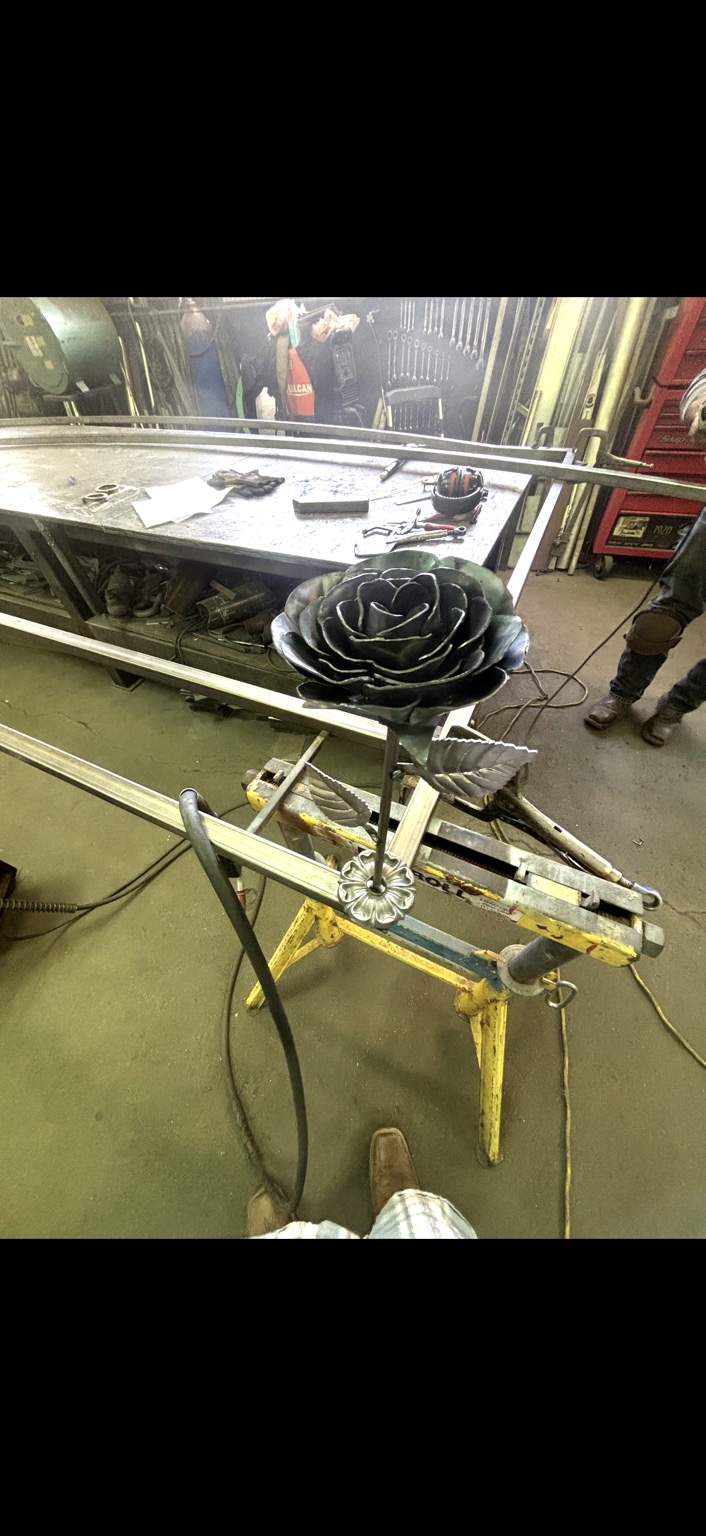 Bare-steel metal rose on a stand in the Wolf Pack workshop