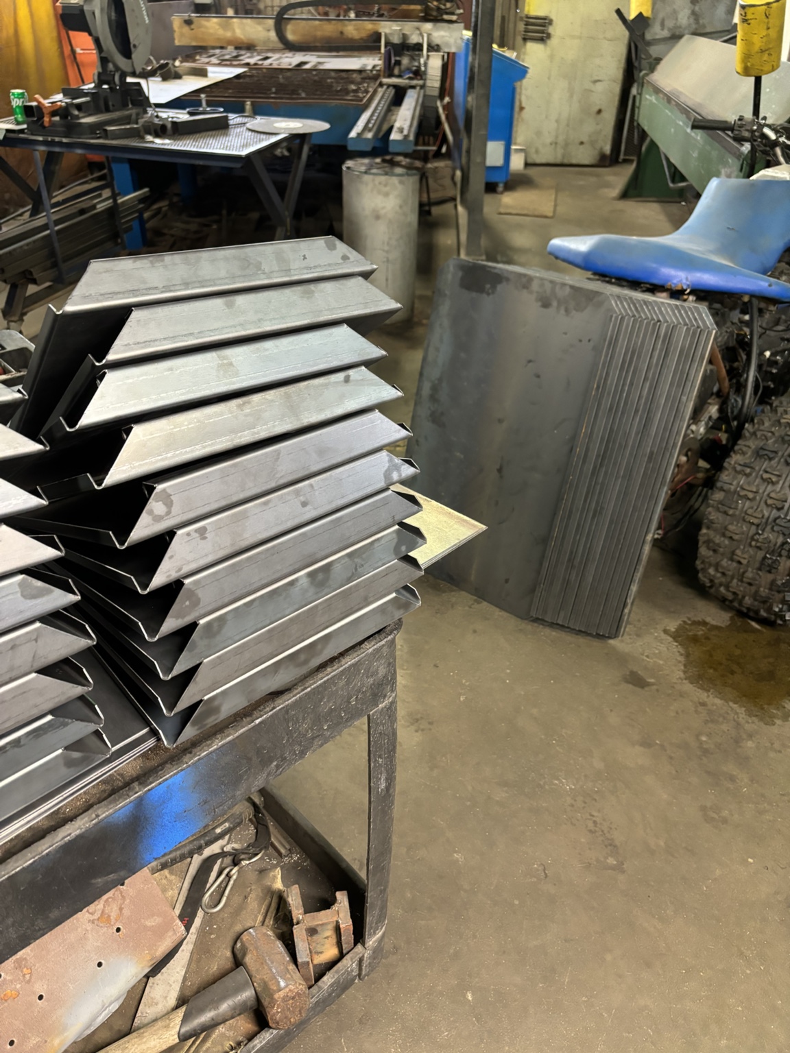 Stacks of matching formed steel parts in the Wolf Pack shop